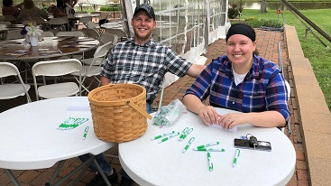 Two volunteers at check in table for event